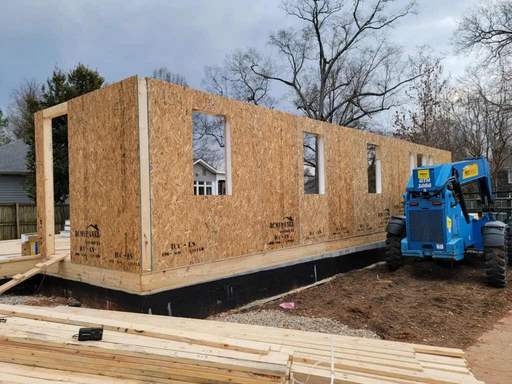 ACME Panel SIP wall panels being set with a skid steer loader during construction of a Charlotte, NC home