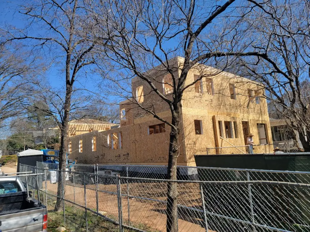 Two-story SIP home under construction in Charlotte's Elizabeth neighborhood with roof framing underway