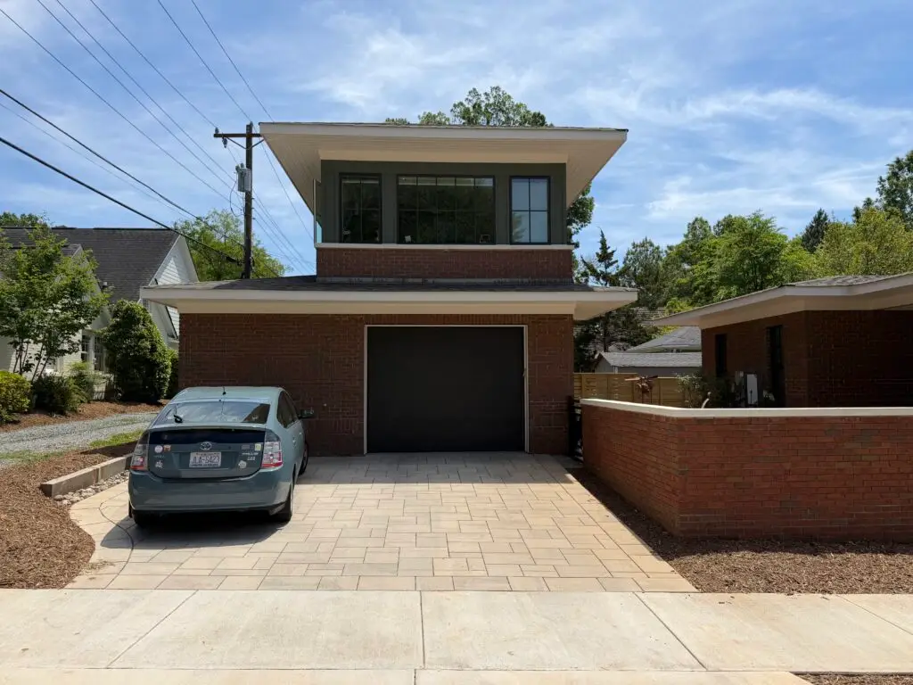 Completed two-story carriage house with a ground-floor garage and second-floor home office in Charlotte, NC