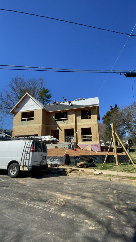 Workers installing the roof over SIP walls on a two-story home in Vienna, Virginia