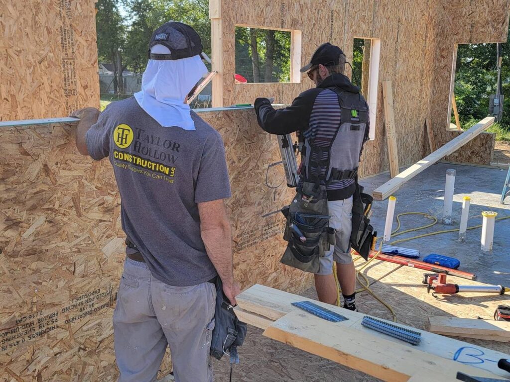 Taylor Hollow Construction crew framing an ACME SIP wall on site