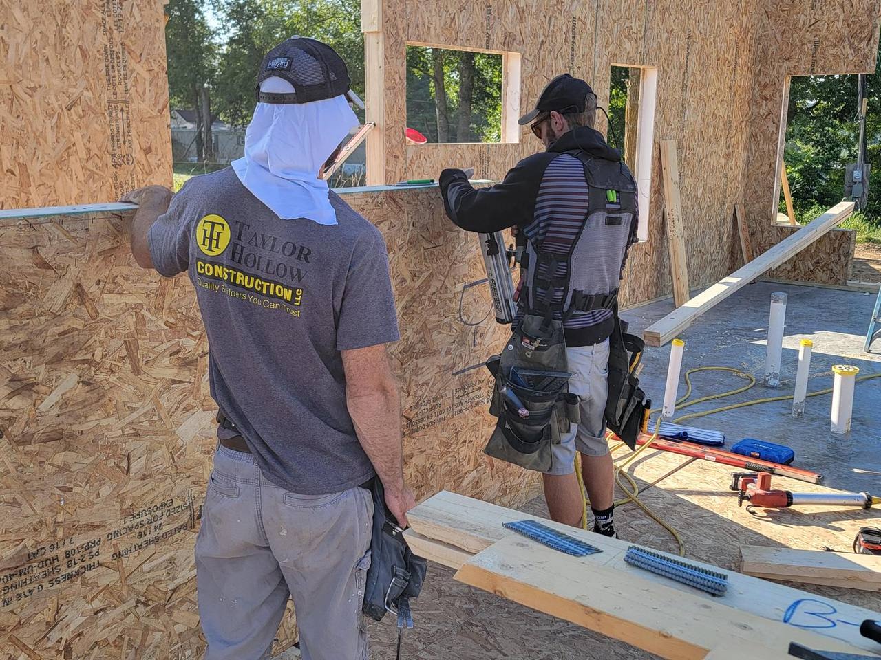 Taylor Hollow Construction crew framing an ACME SIP wall on site