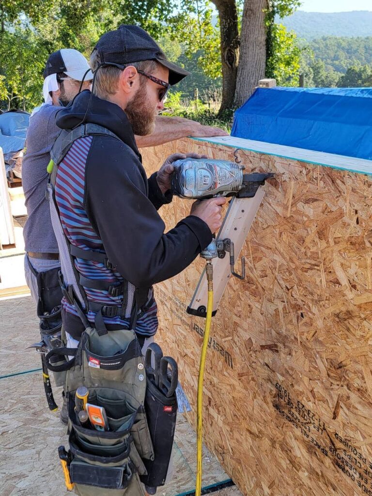 Securing the OSB skin on an ACME structural insulated panel with a pneumatic nailer